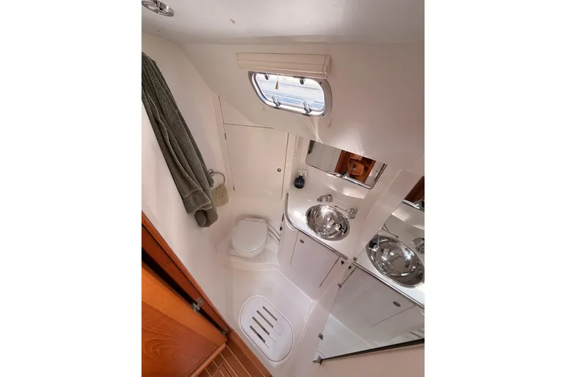 Slide: The Image of Bathroom interior of 1999 Jeanneau Sun Odyssey 45.2 yacht, featuring sink and toilet. - 50