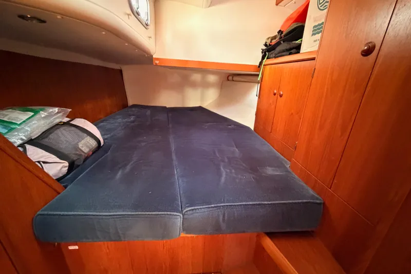Slide: The Image of Cozy cabin interior of 1999 Jeanneau Sun Odyssey 45.2 sailboat with blue bedding. - 54