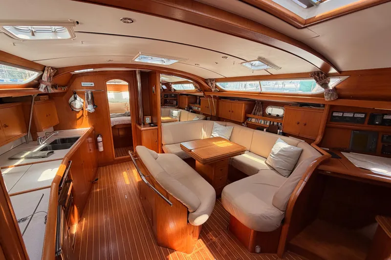 Slide: The Image of Interior of 1999 Jeanneau Sun Odyssey 45.2 yacht with elegant wood finish and cozy seating. - 55