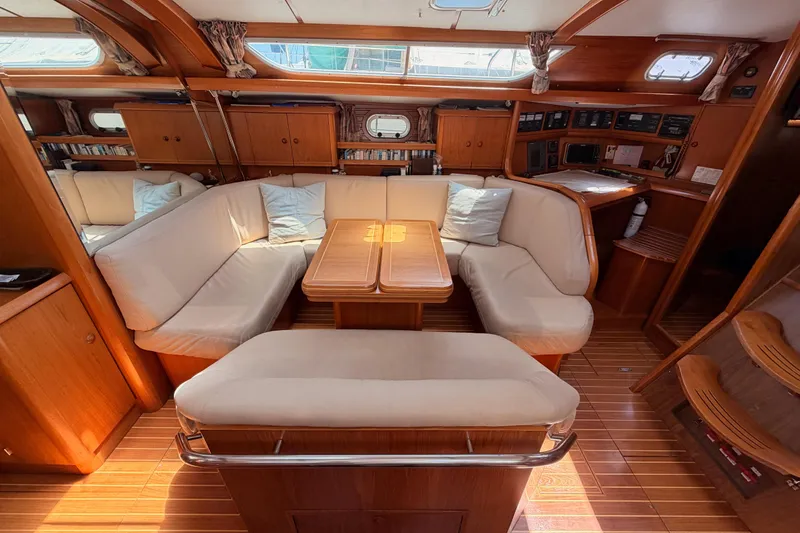 Slide: The Image of Interior of 1999 Jeanneau Sun Odyssey 45.2 yacht with cozy seating and wooden finishes. - 56