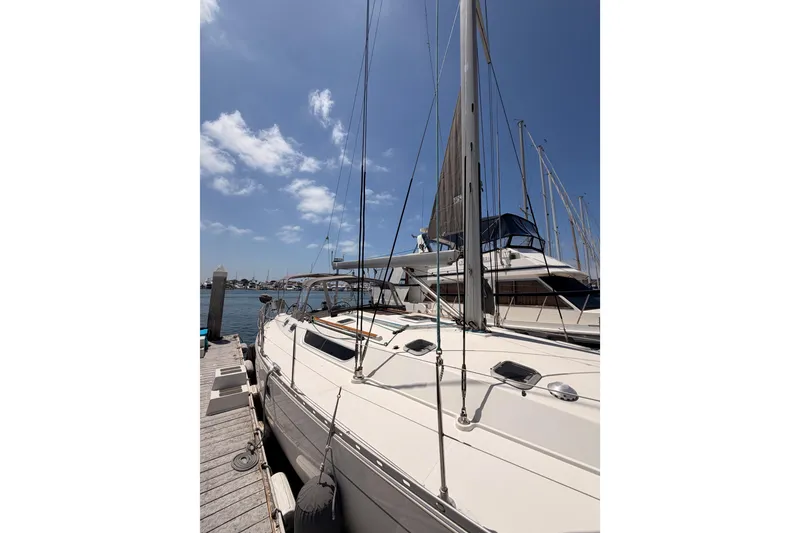 Slide: The Image of 1999 Jeanneau Sun Odyssey 45.2 sailboat docked under a clear blue sky. - 6