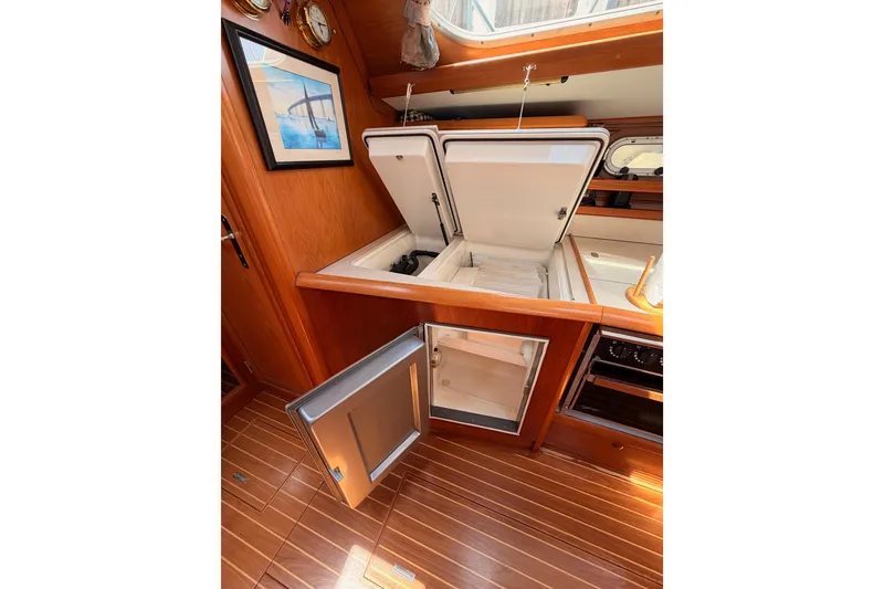 Slide: The Image of Interior of 1999 Jeanneau Sun Odyssey 45.2 yacht with open storage compartments. - 61