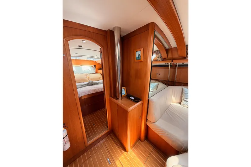 Slide: The Image of Interior of 1999 Jeanneau Sun Odyssey 45.2 yacht, featuring cozy wooden cabin design. - 64