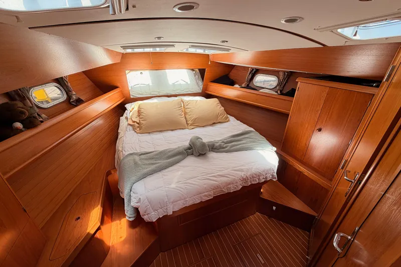Slide: The Image of Cozy cabin interior of 1999 Jeanneau Sun Odyssey 45.2 sailboat with wooden furnishings. - 66