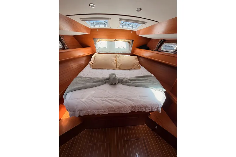 Slide: The Image of Cozy cabin interior of 1999 Jeanneau Sun Odyssey 45.2 with wooden finish and comfortable bedding. - 67