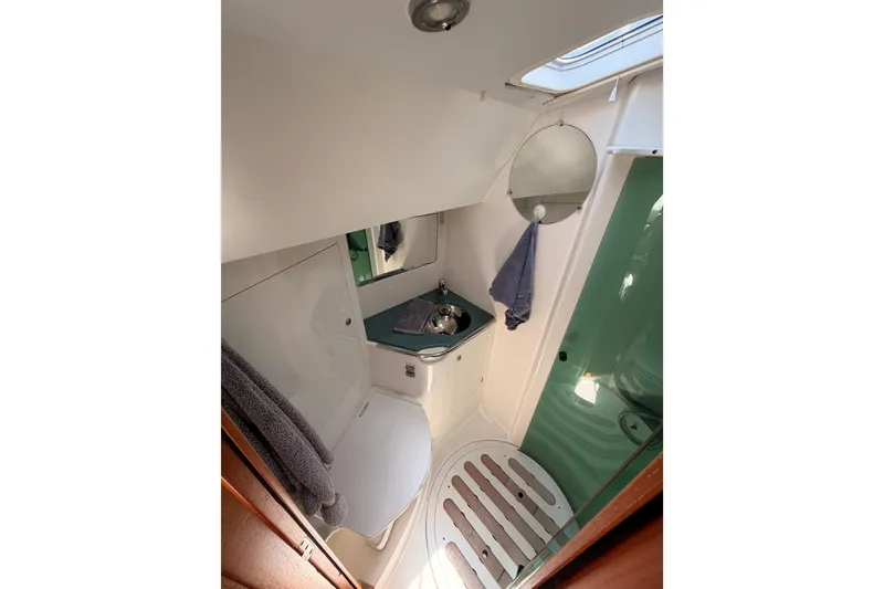 Slide: The Image of Compact bathroom in 1999 Jeanneau Sun Odyssey 45.2 yacht with sink, mirror, and towel. - 69