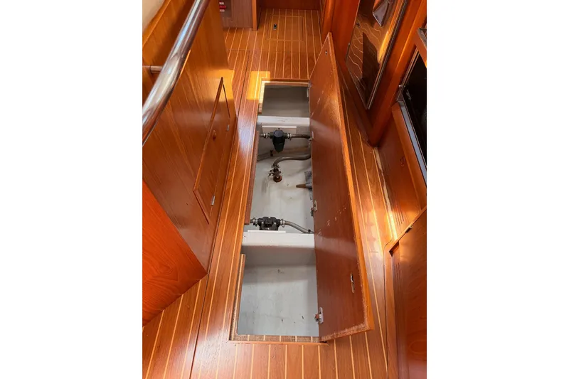 Slide: The Image of Open floor compartment on 1999 Jeanneau Sun Odyssey 45.2 sailboat, showcasing interior storage. - 76