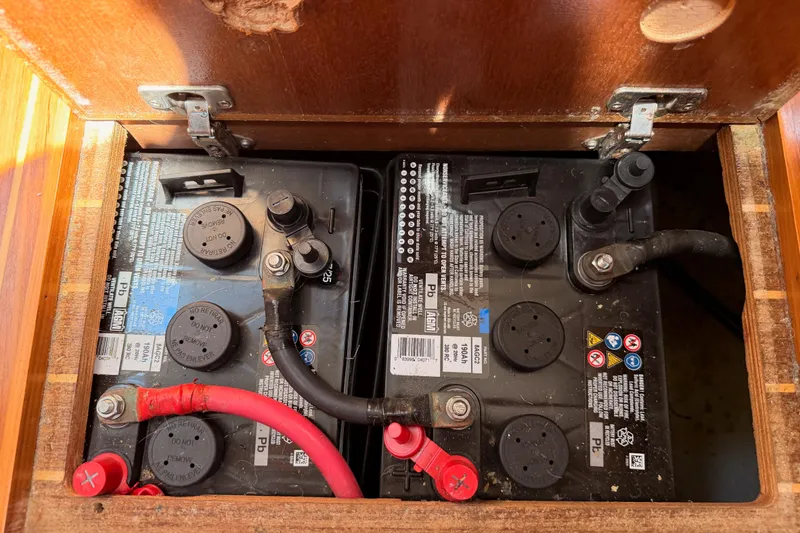 Slide: The Image of Battery compartment of a 1999 Jeanneau Sun Odyssey 45.2 sailboat, showing two connected batteries. - 77