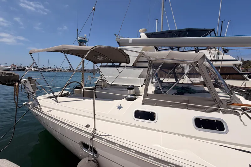 Slide: The Image of 1999 Jeanneau Sun Odyssey 45.2 sailboat docked at marina under clear blue sky. - 8