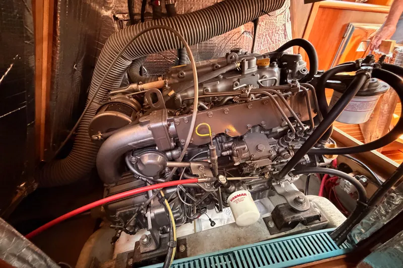 Slide: The Image of Engine compartment of a 1999 Jeanneau Sun Odyssey 45.2 sailboat, featuring a Yanmar engine. - 80