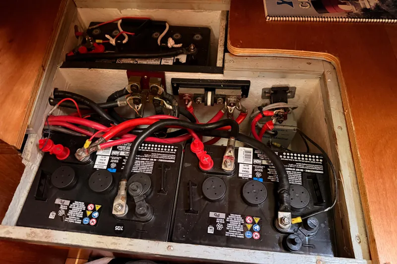 Slide: The Image of Battery compartment of a 1999 Jeanneau Sun Odyssey 45.2 sailboat with wiring connections. - 83