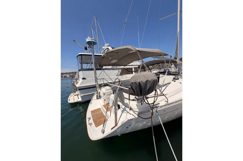 Slide: The Image of 1999 Jeanneau Sun Odyssey 45.2 sailboat docked in marina under clear blue sky. - 9