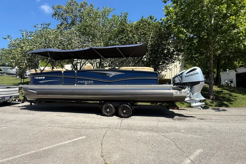 The Image of 2023 Premier 270 Intrigue RF pontoon boat with Honda outboard motor on trailer. - 1