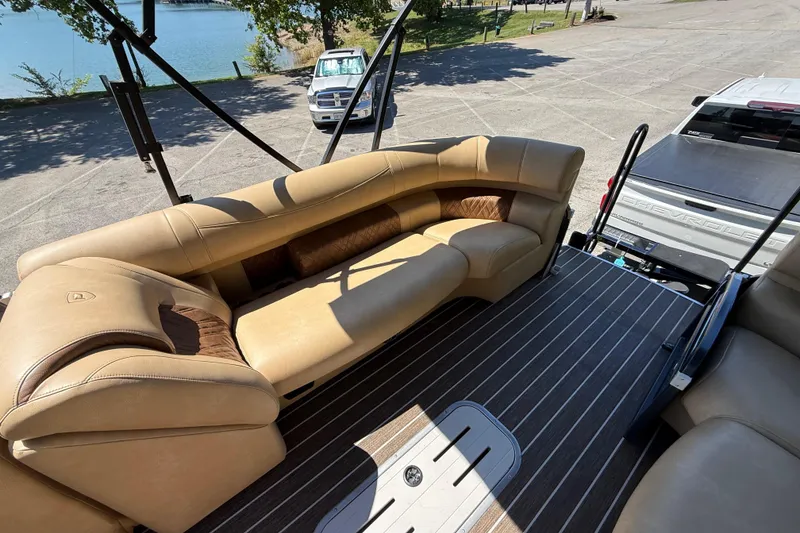 Slide: The Image of Luxurious seating on 2023 Premier 270 Intrigue RF boat, parked near a scenic lake. - 10