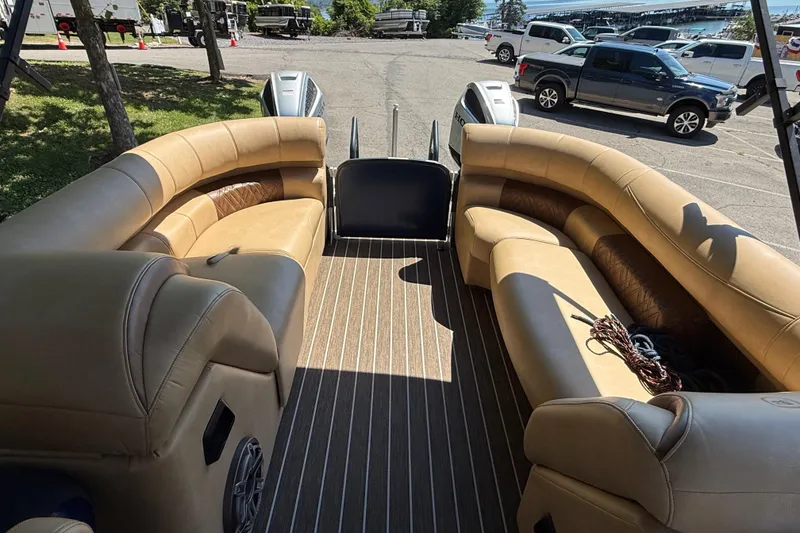 Slide: The Image of Luxurious seating on 2023 Premier 270 Intrigue RF pontoon boat, parked near vehicles. - 3