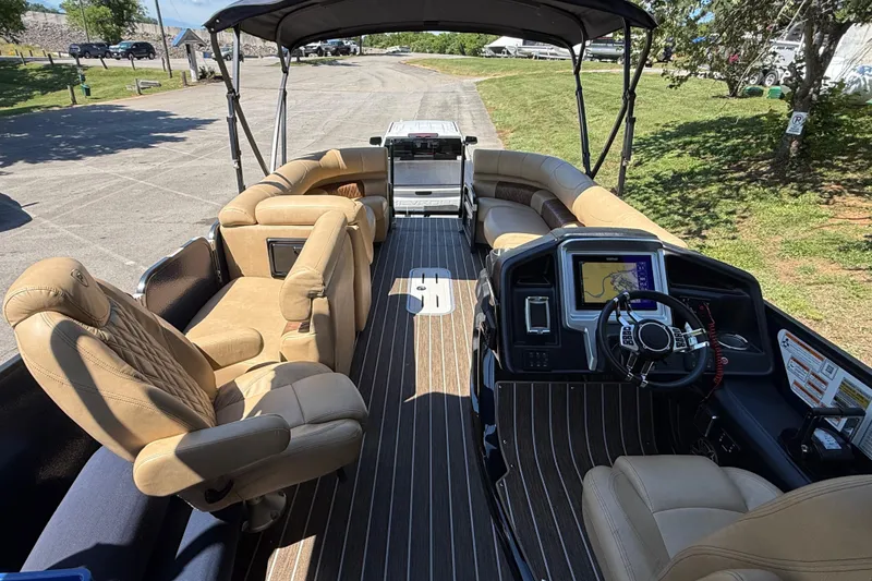 Slide: The Image of Luxurious 2023 Premier 270 Intrigue RF pontoon boat interior with plush seating and modern dashboard. - 4