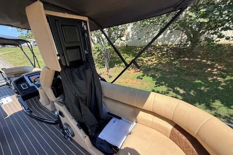 Slide: The Image of 2023 Premier 270 Intrigue RF boat interior with beige seating and modern dashboard. - 6