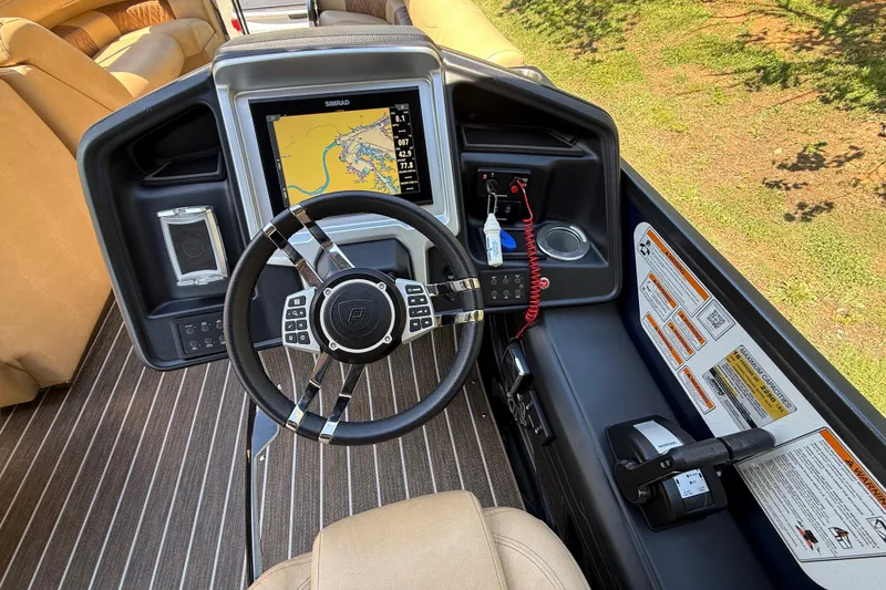 Slide: The Image of 2023 Premier 270 Intrigue RF boat dashboard with navigation screen and controls. - 7