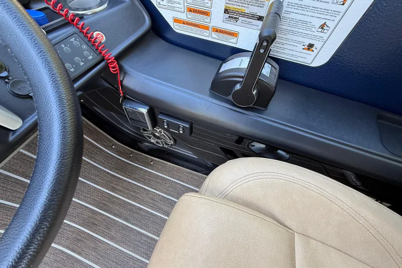 Slide: The Image of Interior view of 2023 Premier 270 Intrigue RF boat cockpit with steering wheel and controls. - 8