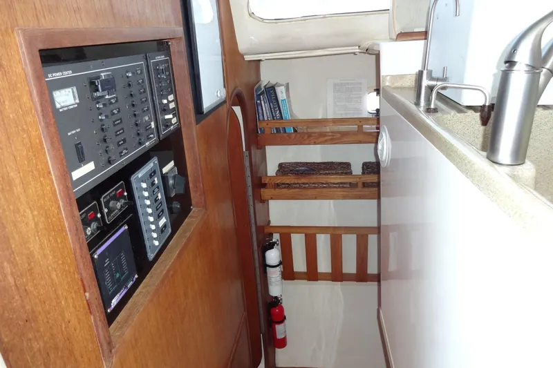 Slide: The Image of Interior of 1996 Lagoon 35 CCC yacht showing control panel and compact kitchen area. - 102