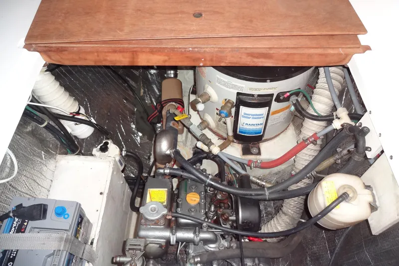 Slide: The Image of Engine compartment of a 1996 Lagoon 35 CCC sailboat, featuring mechanical components and wiring. - 103