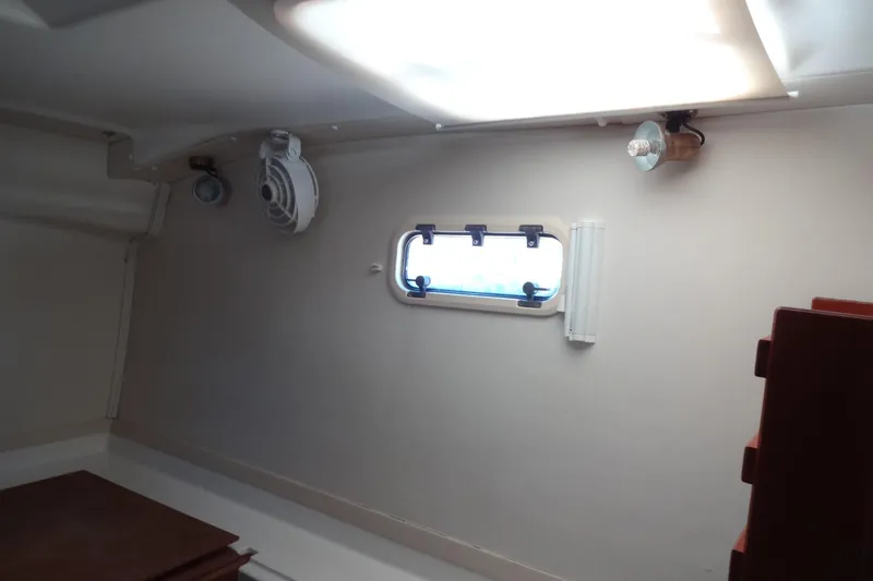 Slide: The Image of Interior cabin of 1996 Lagoon 35 CCC yacht with porthole and lighting fixtures. - 105