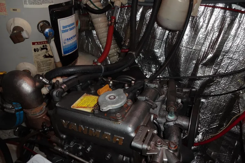 Slide: The Image of Engine compartment of a 1996 Lagoon 35 CCC with Yanmar engine and water heater. - 109