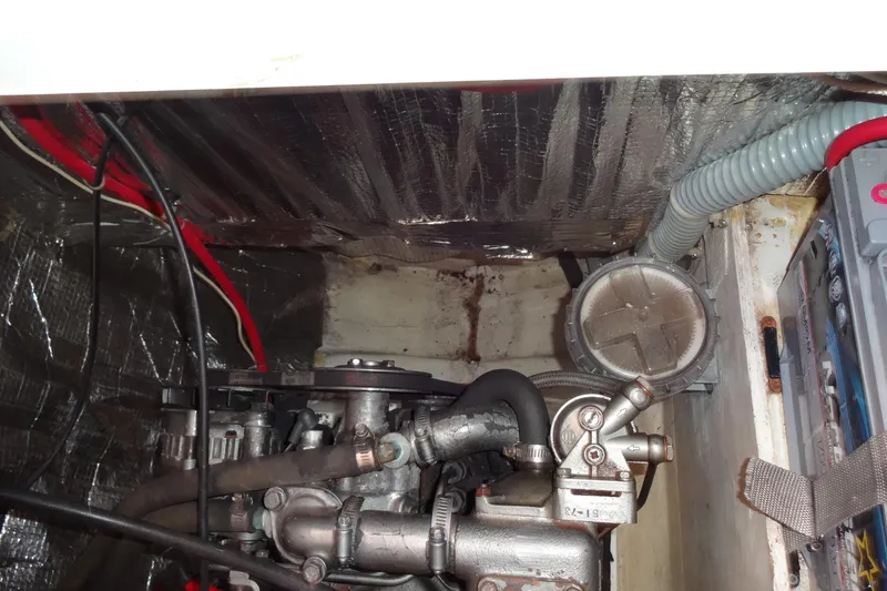Slide: The Image of Engine compartment of a 1996 Lagoon 35 CCC sailboat, showing mechanical components and wiring. - 110