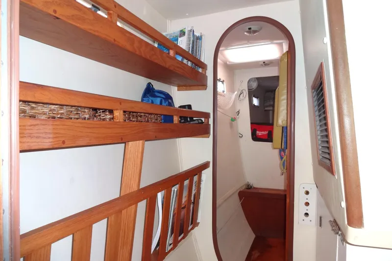 Slide: The Image of Interior of 1996 Lagoon 35 CCC sailboat with wooden shelves and cozy cabin space. - 112