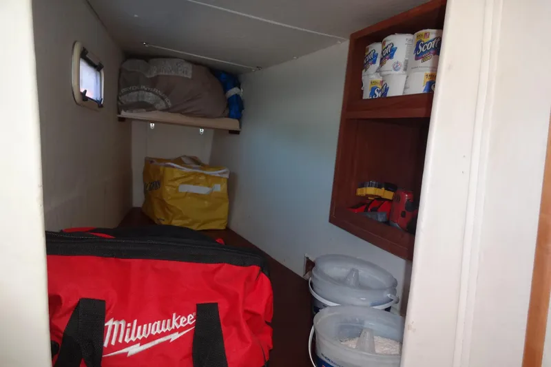 Slide: The Image of Storage area inside 1996 Lagoon 35 CCC boat with tools and supplies. - 114