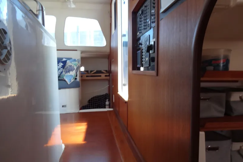 Slide: The Image of Interior of 1996 Lagoon 35 CCC sailboat, featuring wood paneling and cozy seating area. - 118