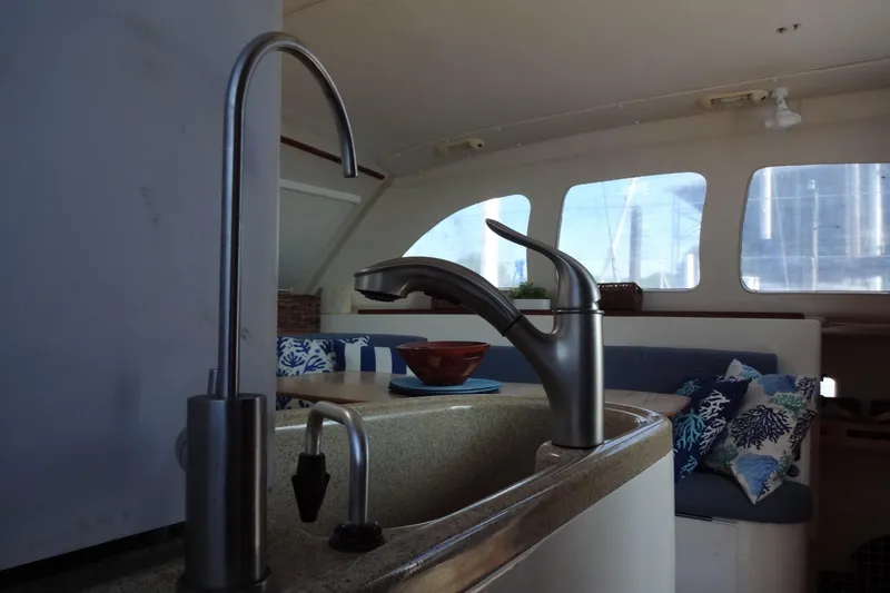 Slide: The Image of Interior of 1996 Lagoon 35 CCC yacht with modern kitchen faucet and cozy seating area. - 119