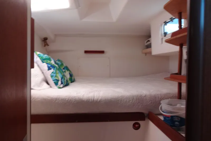 Slide: The Image of Cozy cabin interior of 1996 Lagoon 35 CCC with bed and colorful pillows. - 121