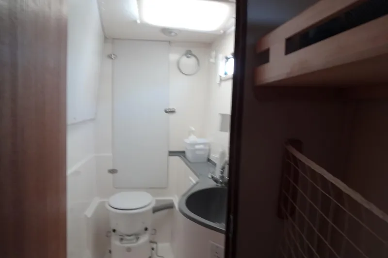 Slide: The Image of Bathroom interior of a 1996 Lagoon 35 CCC yacht, featuring a compact design. - 123