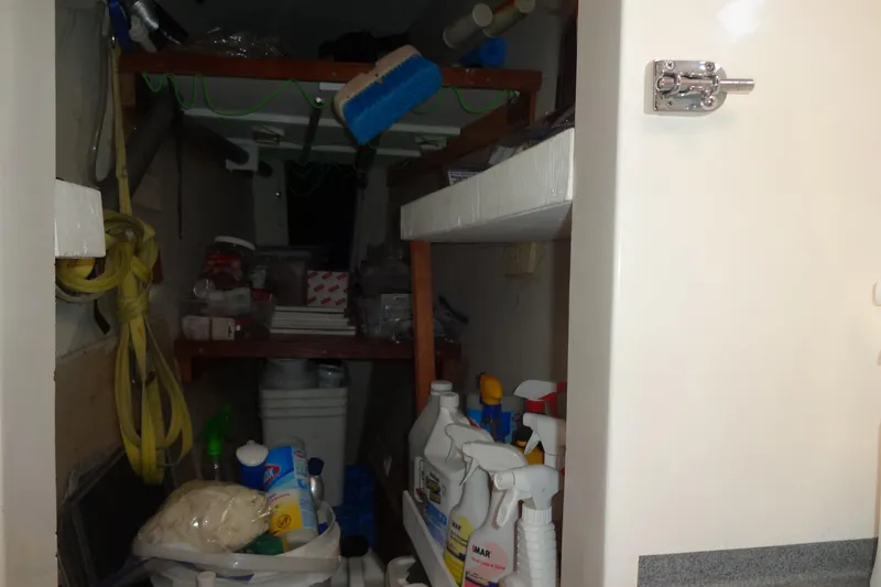 Slide: The Image of Storage area on a 1996 Lagoon 35 CCC yacht, filled with cleaning supplies and equipment. - 126