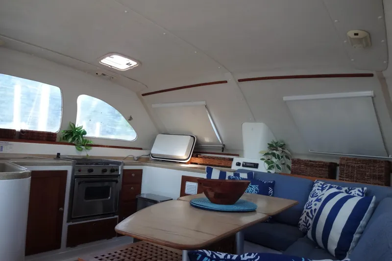Slide: The Image of Interior of 1996 Lagoon 35 CCC yacht with cozy seating and kitchen area. - 128