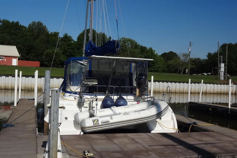 Slide: The Image of 1996 Lagoon 35 CCC catamaran docked with inflatable dinghy on deck. - 19