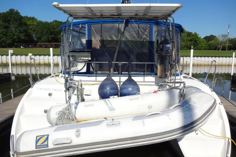 Slide: The Image of 1996 Lagoon 35 CCC catamaran with Zodiac dinghy docked at marina. - 20