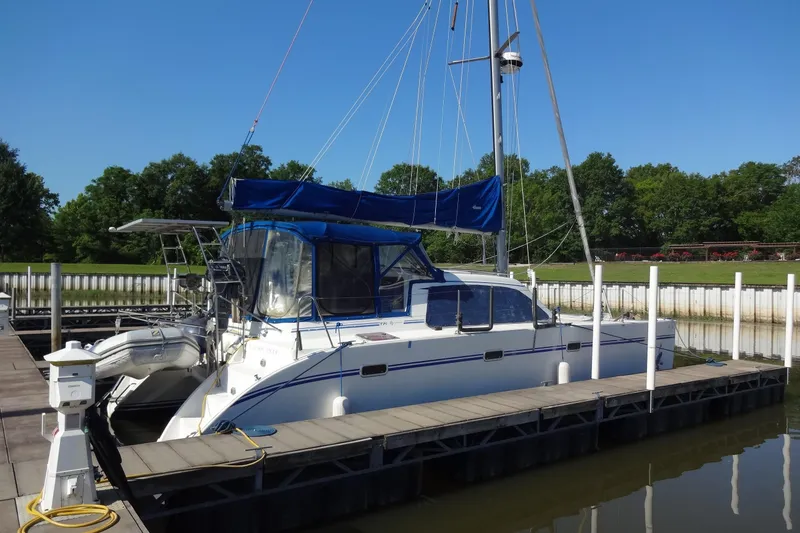 Slide: The Image of 1996 Lagoon 35 CCC catamaran docked at marina with blue canopy. - 22