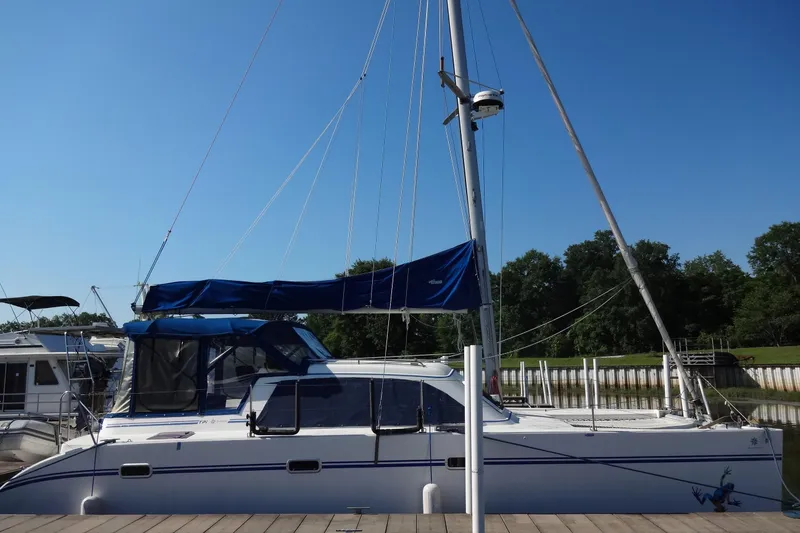 Slide: The Image of Sailboat Lagoon 35 CCC 1996 docked, featuring blue canopy and clear sky background. - 25