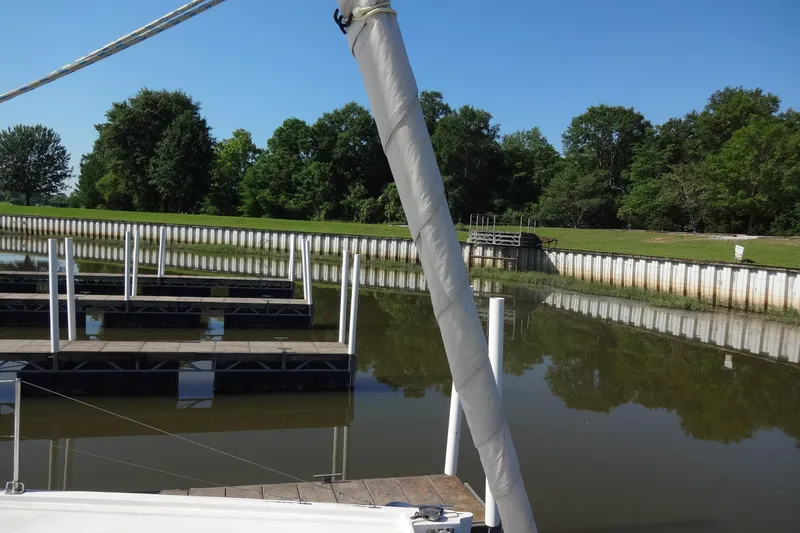 Slide: The Image of Empty marina docks with calm water and lush green trees in the background. - 39