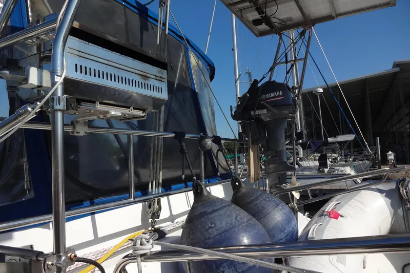 Slide: The Image of Sailboat Lagoon 35 CCC (1996) with Yamaha motor and fenders docked at marina. - 46