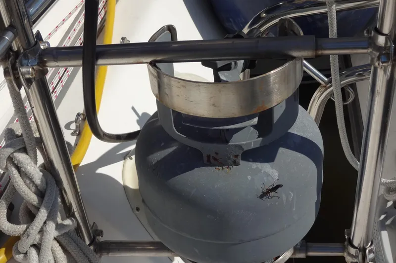 Slide: The Image of Propane tank on 1996 Lagoon 35 CCC yacht deck with ropes and metal railing. - 47
