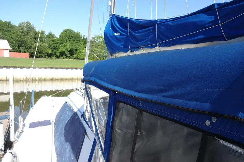 Slide: The Image of Sailboat Lagoon 35 CCC, 1996 model, docked with blue canvas cover. - 53