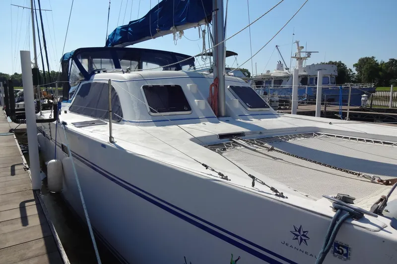 Slide: The Image of 1996 Lagoon 35 CCC catamaran docked, featuring sleek design and spacious deck. - 64