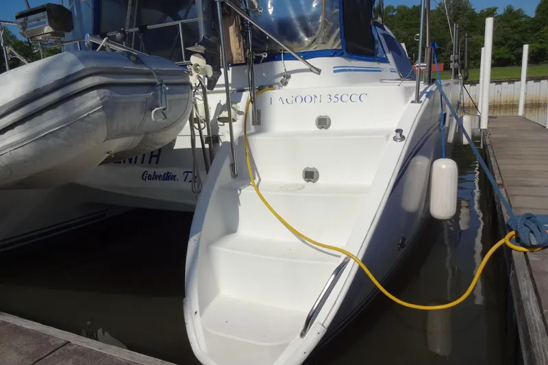 Slide: The Image of 1996 Lagoon 35 CCC catamaran docked with inflatable dinghy and mooring lines. - 67