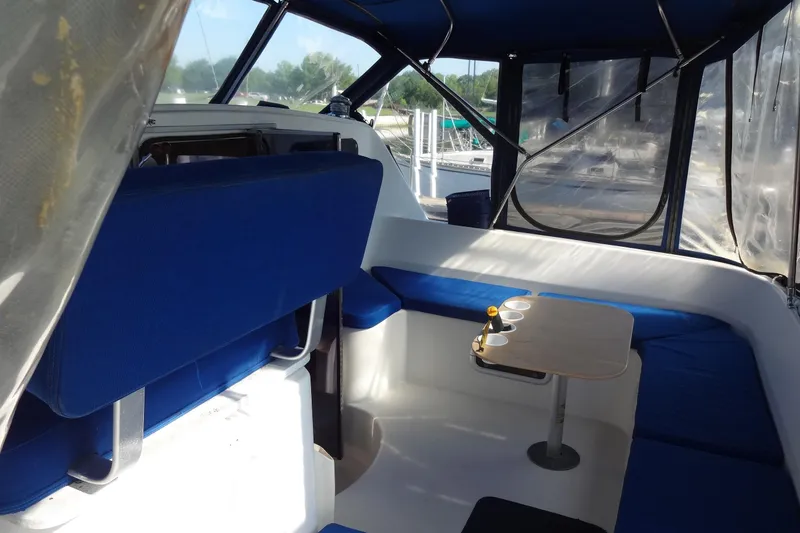 Slide: The Image of Interior of 1996 Lagoon 35 CCC yacht with blue seating and a small table. - 73