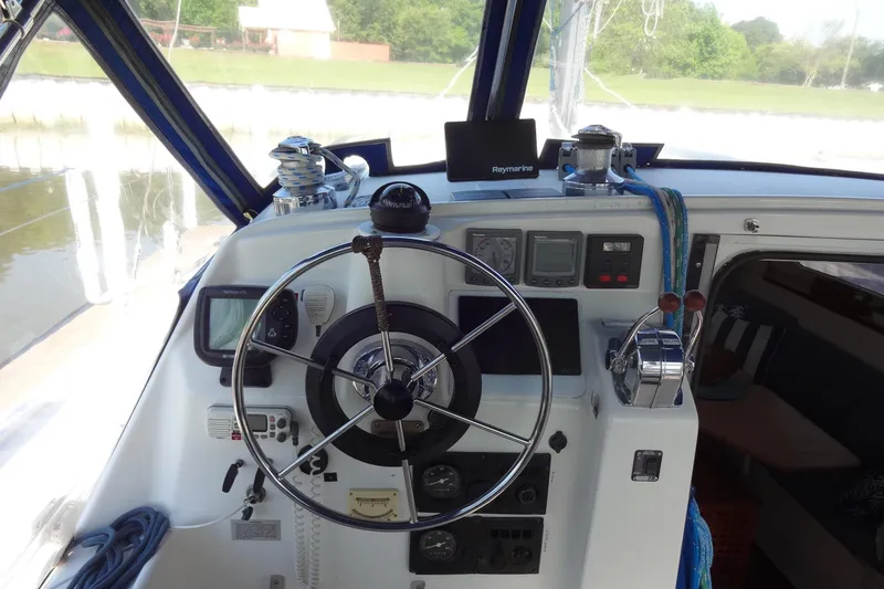 Slide: The Image of Cockpit of 1996 Lagoon 35 CCC sailboat with steering wheel and navigation instruments. - 74