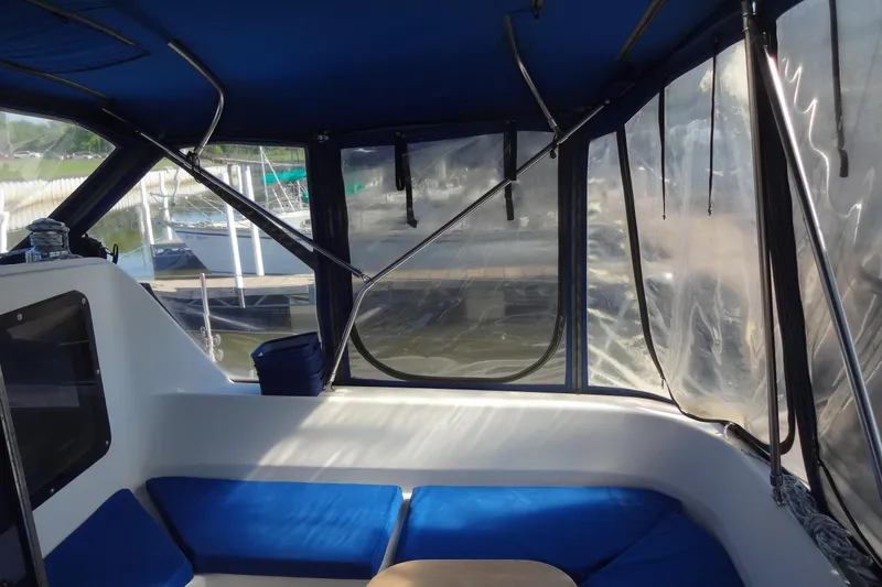 Slide: The Image of Interior view of a 1996 Lagoon 35 CCC sailboat with blue seating and clear windows. - 75