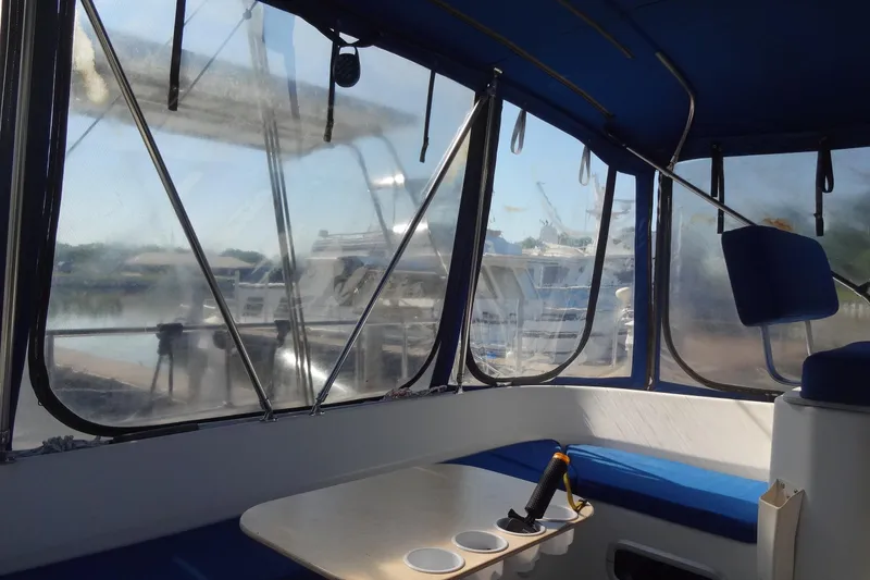 Slide: The Image of Interior view of a 1996 Lagoon 35 CCC boat with marina background. - 76